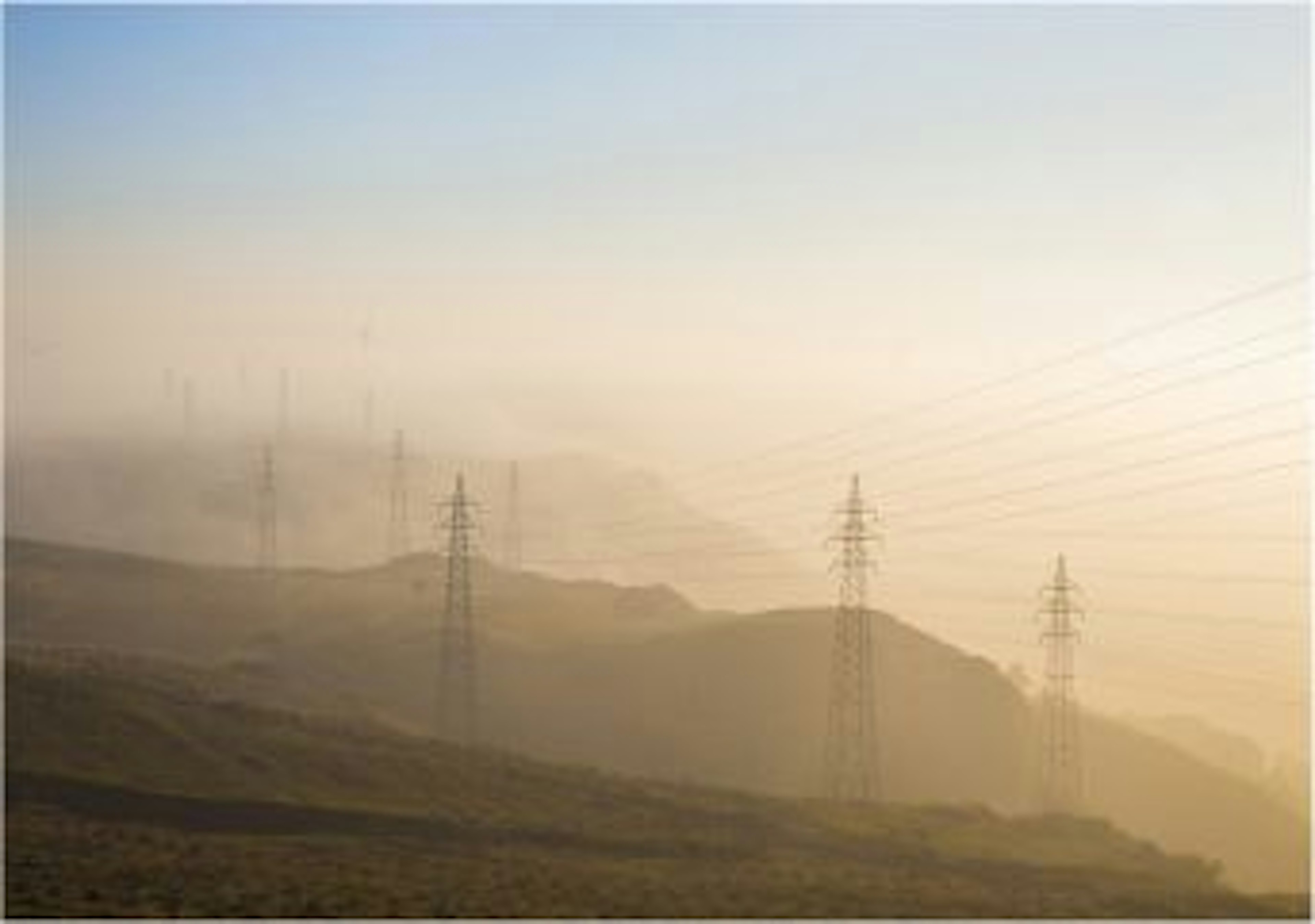 Photo of electricity towers over clouds