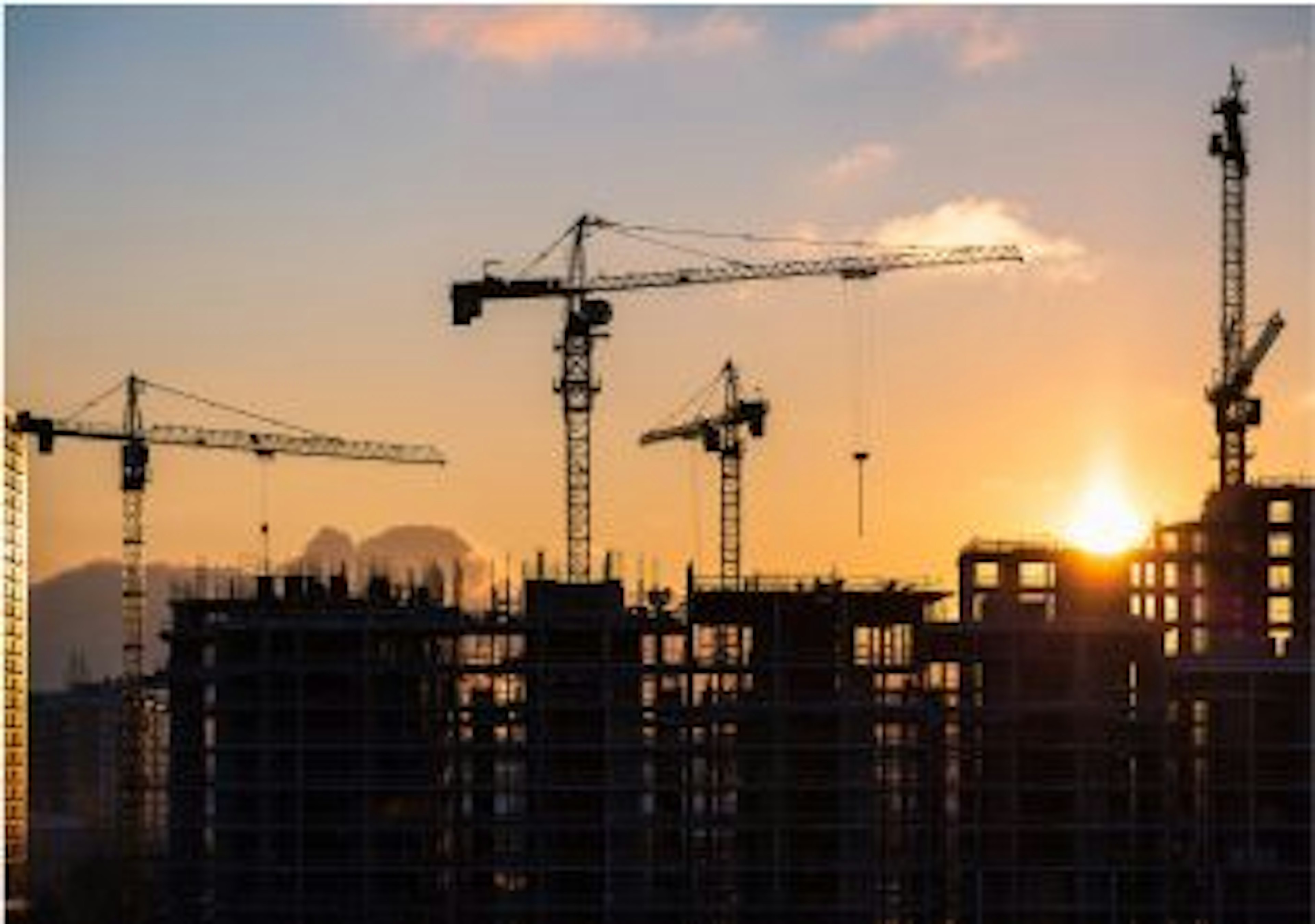 Photo of buildings with the sun going down in the background